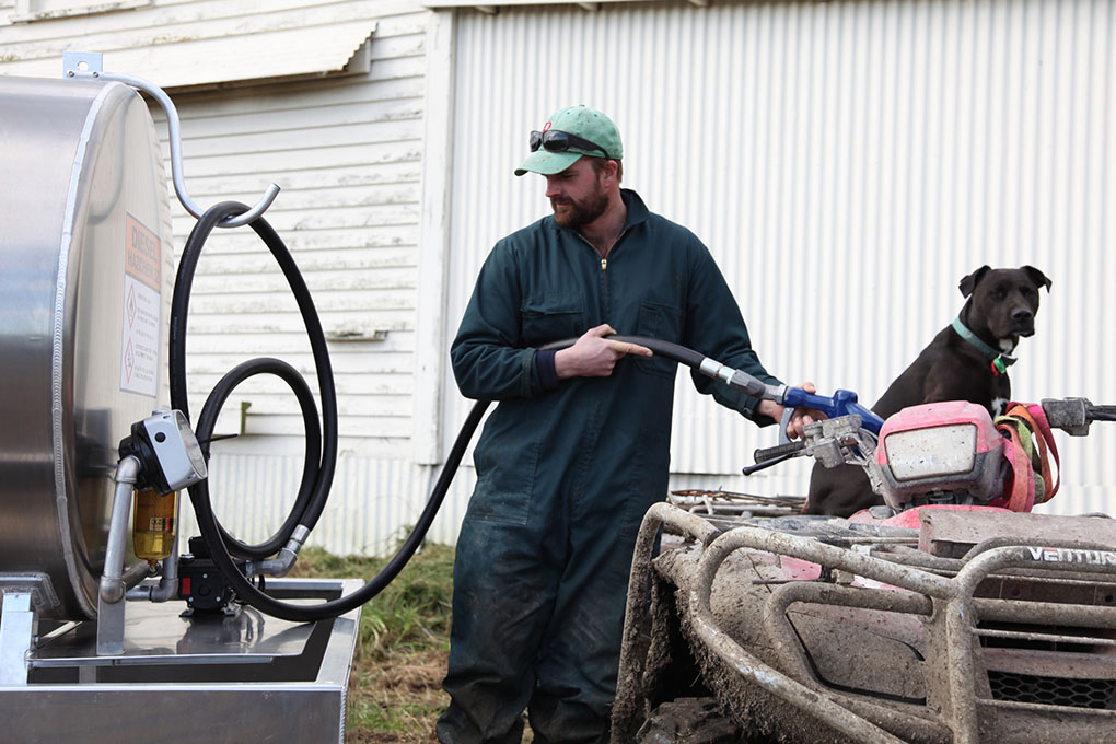 Farmer filling up quad bike